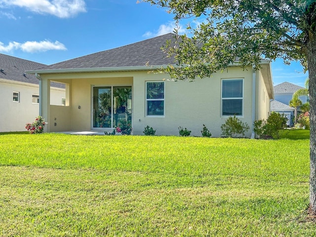 rear view of property with a lawn