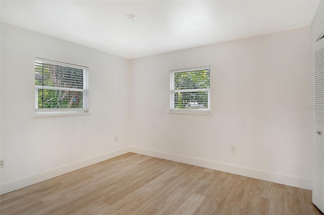 unfurnished room with a wealth of natural light and light wood-type flooring