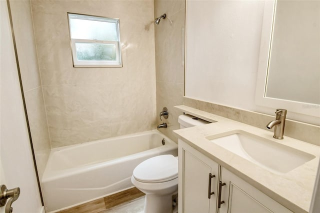 bathroom featuring vanity, toilet, shower / tub combination, and wood finished floors