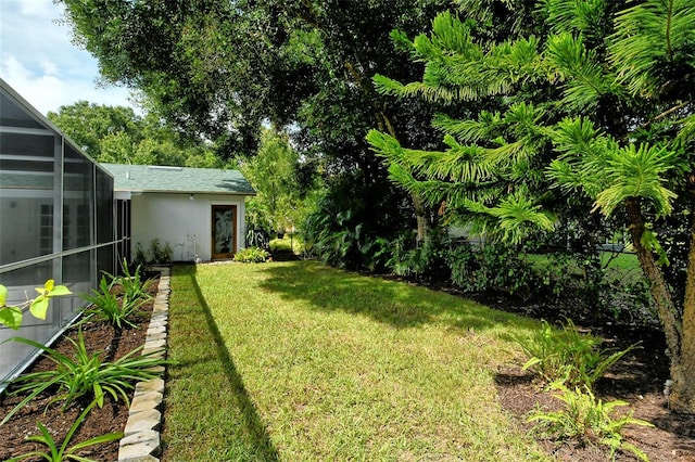 view of yard with glass enclosure