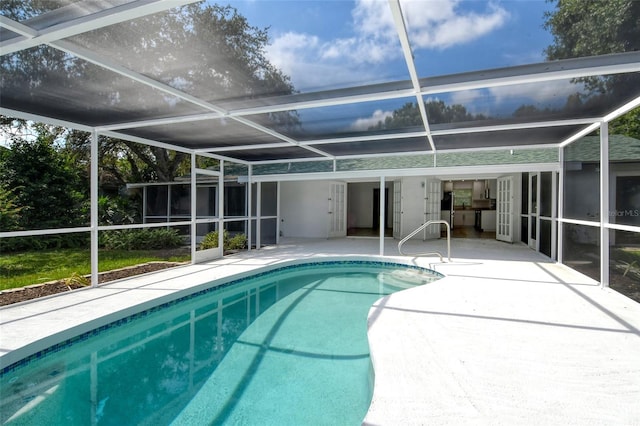 view of swimming pool with a lanai and a patio area