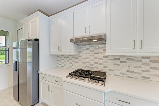 kitchen featuring white cabinets, light tile patterned floors, stainless steel appliances, and tasteful backsplash