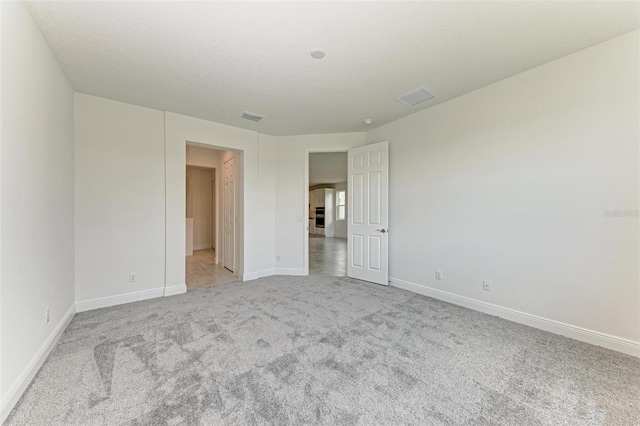 unfurnished bedroom with light colored carpet