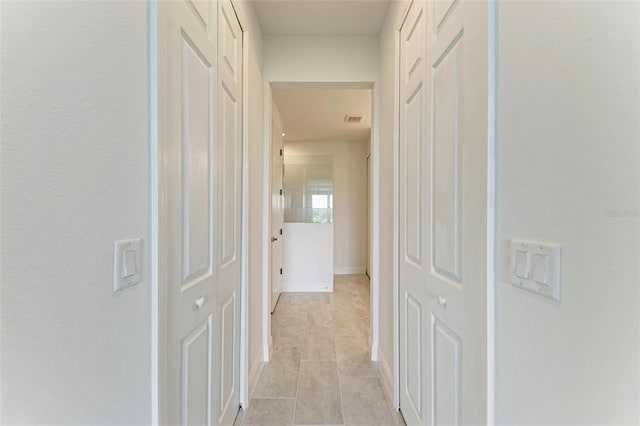 corridor with light tile patterned floors