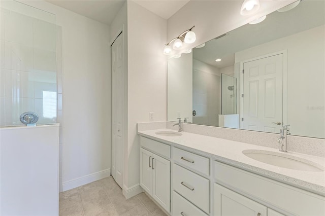 4254 Golden Creek Ter, Parrish, FL 34219 - bathroom with tiled shower, double vanity, baseboards, and tile patterned flooring
