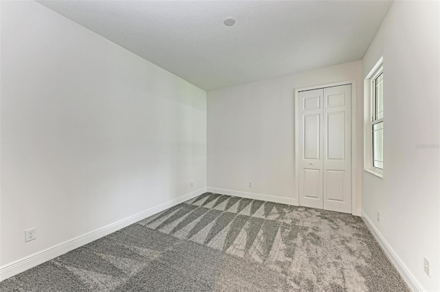 empty room with carpet flooring