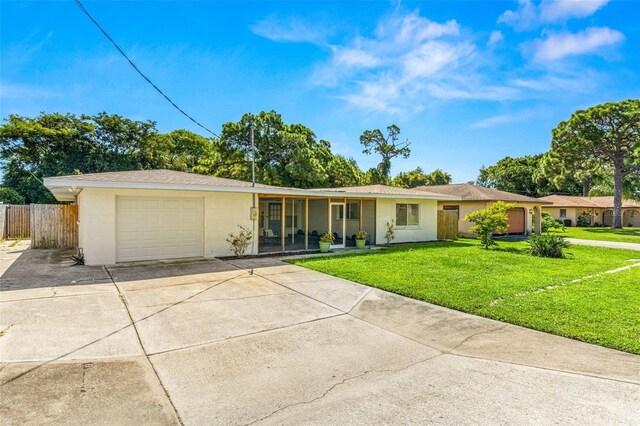 ranch-style house featuring a garage and a front lawn