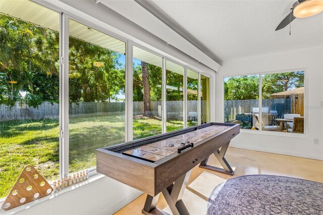 sunroom featuring a healthy amount of sunlight and ceiling fan