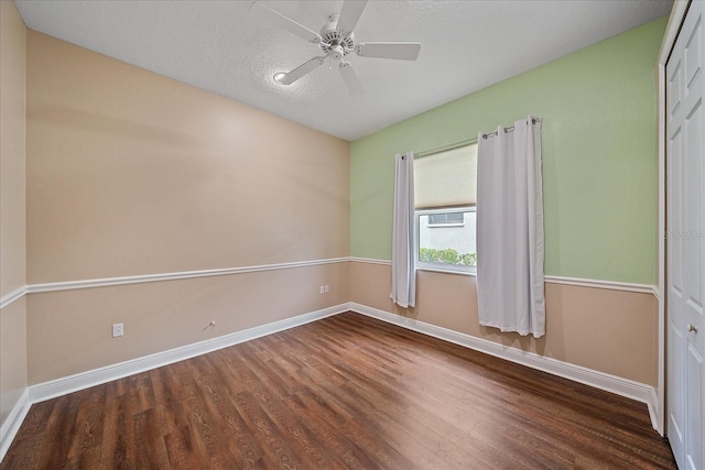 spare room with a textured ceiling, hardwood / wood-style flooring, and ceiling fan