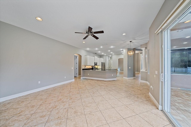 unfurnished living room with ceiling fan