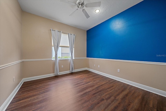 spare room with ceiling fan, dark hardwood / wood-style floors, and a textured ceiling