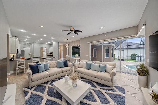 living room with light tile patterned floors, sink, and ceiling fan