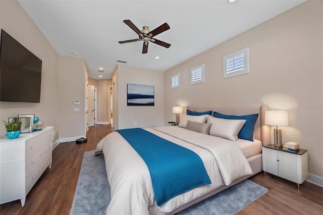 bedroom with ceiling fan and dark hardwood / wood-style flooring