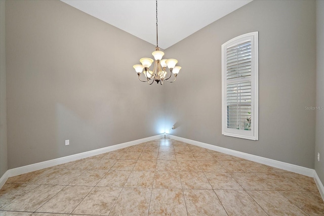 tiled spare room featuring vaulted ceiling and a chandelier