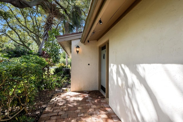 view of side of property with central AC and a patio