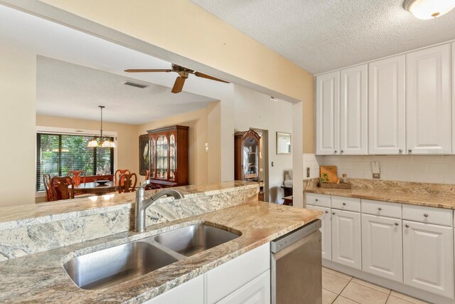 kitchen with dishwasher, decorative light fixtures, ceiling fan with notable chandelier, sink, and decorative backsplash