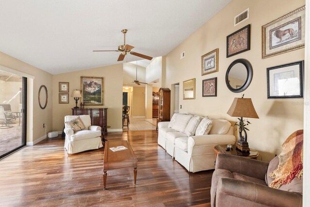 living room featuring vaulted ceiling, hardwood / wood-style flooring, and ceiling fan