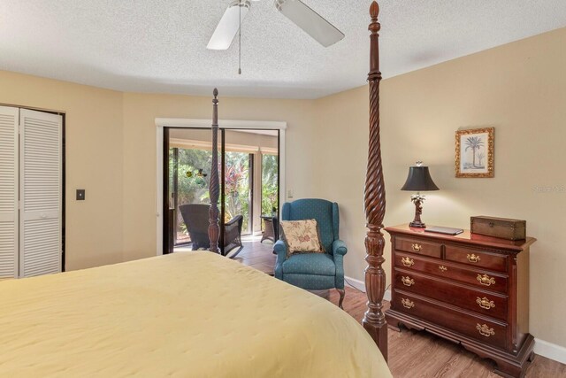 bedroom featuring a textured ceiling, access to outside, wood-type flooring, ceiling fan, and a closet