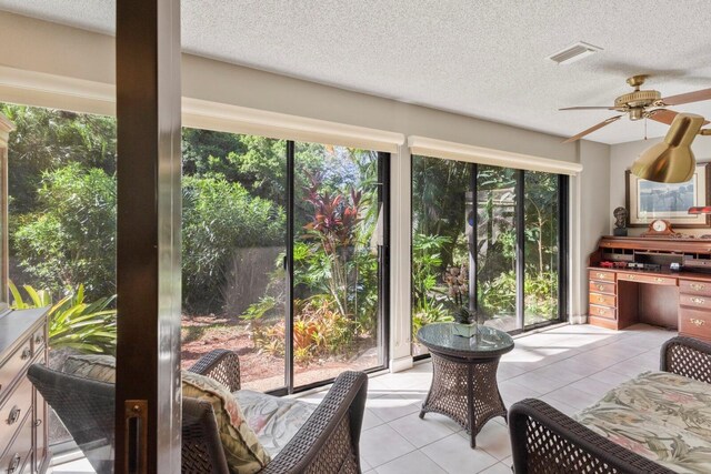 sunroom / solarium with ceiling fan and a healthy amount of sunlight