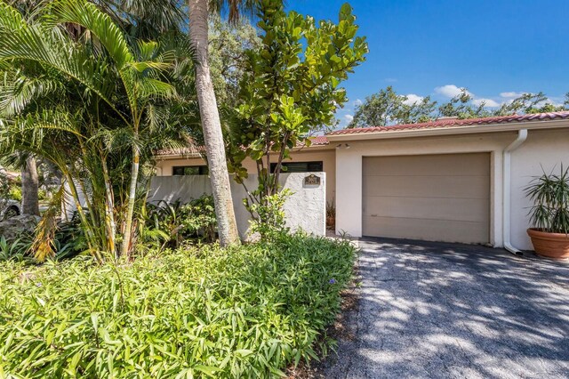 3601 Quail Hollow Ln, Bradenton, FL 34210 - mediterranean / spanish house featuring driveway, stucco siding, an attached garage, and a tiled roof