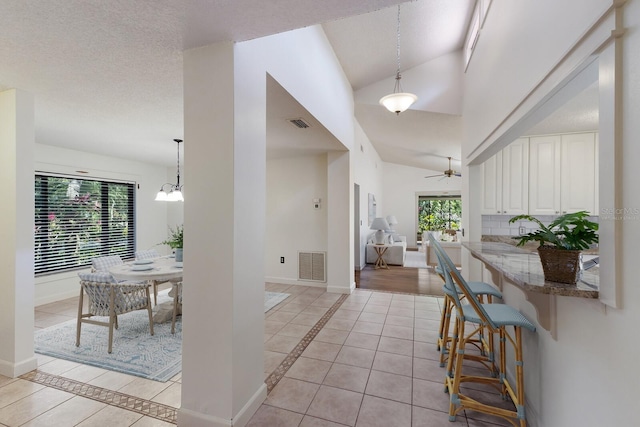 3601 Quail Hollow Ln, Bradenton, FL 34210 - entrance foyer with light tile patterned floors, inlaid floor details, a ceiling fan, baseboards, and lofted ceiling