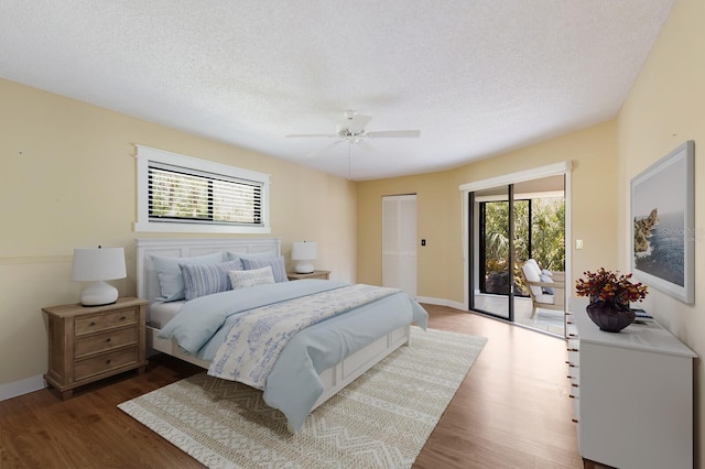 3601 Quail Hollow Ln, Bradenton, FL 34210 - bedroom featuring access to outside, wood finished floors, baseboards, a ceiling fan, and a textured ceiling