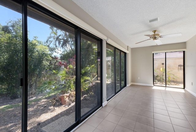 3601 Quail Hollow Ln, Bradenton, FL 34210 - unfurnished sunroom with baseboards, tile patterned flooring, and a textured ceiling