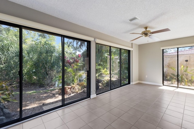 3601 Quail Hollow Ln, Bradenton, FL 34210 - empty room with ceiling fan, baseboards, a textured ceiling, and tile patterned flooring