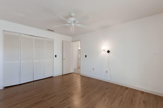 3601 Quail Hollow Ln, Bradenton, FL 34210 - unfurnished bedroom featuring wood finished floors, baseboards, a closet, and a ceiling fan