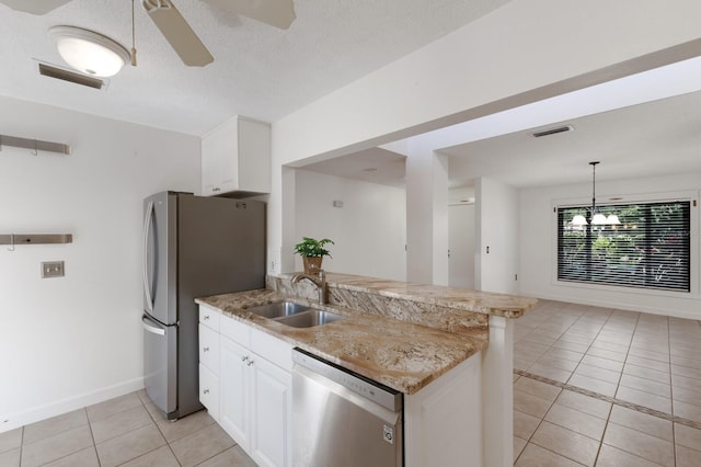 3601 Quail Hollow Ln, Bradenton, FL 34210 - kitchen featuring stainless steel appliances, light tile patterned floors, a peninsula, white cabinetry, and ceiling fan