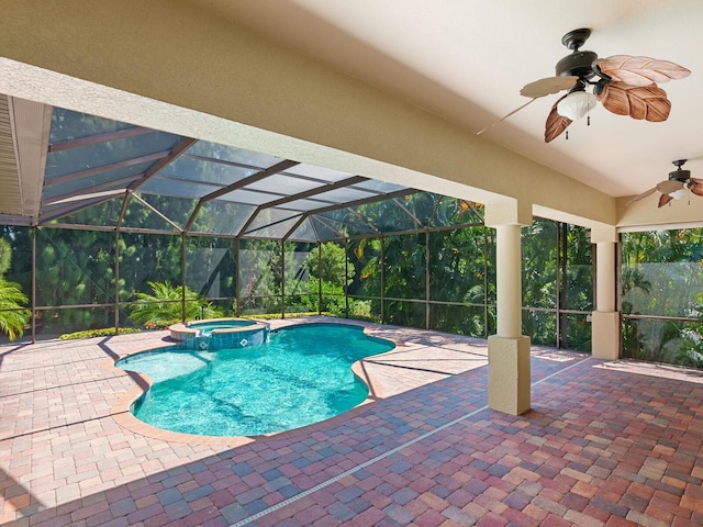 view of swimming pool featuring glass enclosure, ceiling fan, a patio area, and an in ground hot tub