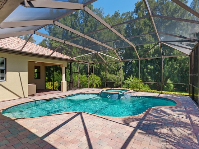 view of pool featuring an in ground hot tub, a lanai, and a patio area