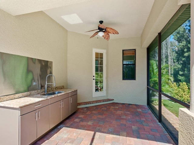 interior space with ceiling fan and sink