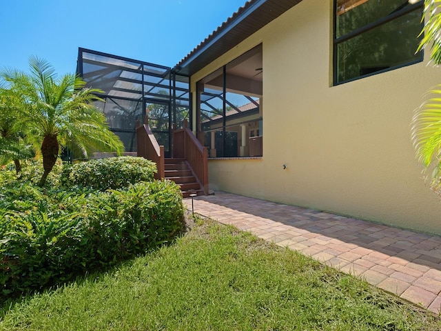 property entrance featuring a lawn