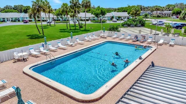 view of pool featuring a yard