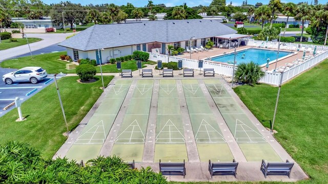 exterior space featuring a lawn and a community pool