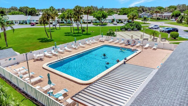 view of pool featuring a yard and a patio