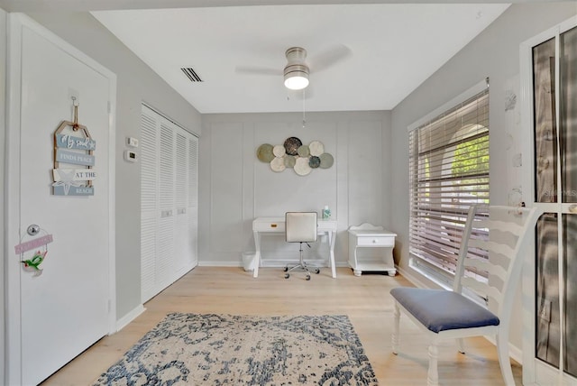 office space with ceiling fan and light hardwood / wood-style flooring