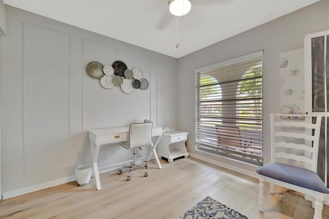 home office featuring light wood-type flooring and ceiling fan