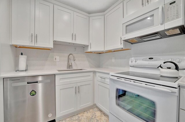 kitchen featuring white cabinets, white appliances, and sink