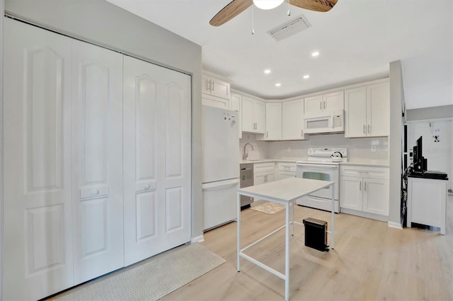 kitchen with white cabinets, white appliances, light hardwood / wood-style flooring, and ceiling fan