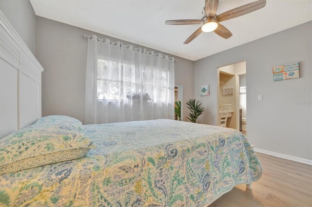 bedroom with ceiling fan and hardwood / wood-style flooring