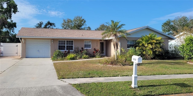 single story home with a front lawn and a garage