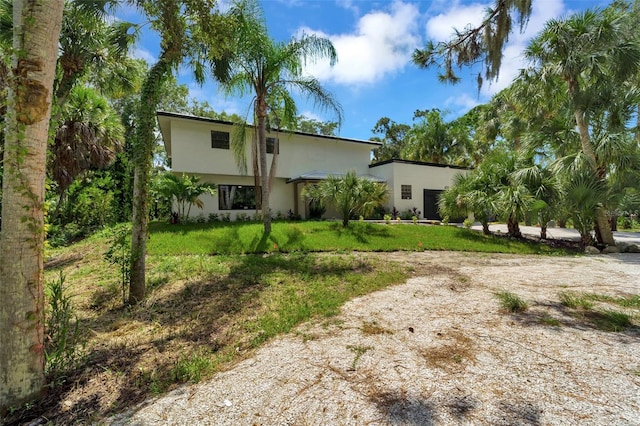 rear view of house featuring a lawn