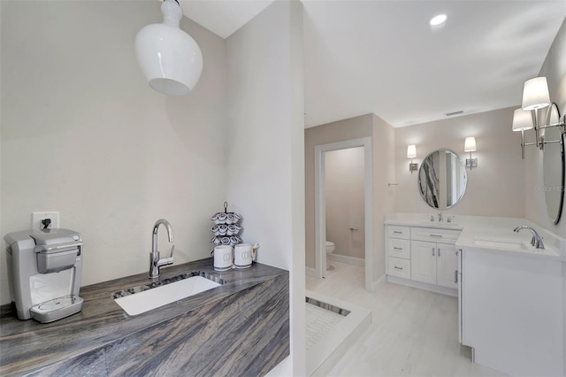 bathroom with vanity and toilet