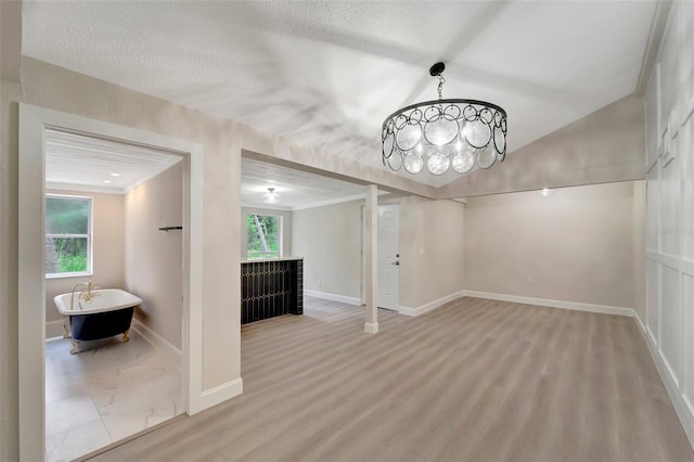 unfurnished dining area with a textured ceiling and light hardwood / wood-style flooring