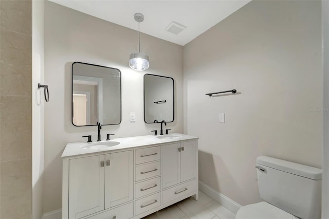 bathroom featuring vanity, toilet, and tile patterned floors