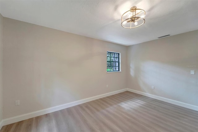 unfurnished room with hardwood / wood-style floors