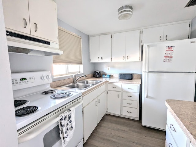 kitchen with white cabinets, white appliances, dark hardwood / wood-style floors, and sink