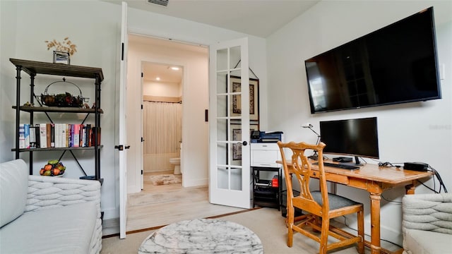 office area with french doors and light hardwood / wood-style flooring